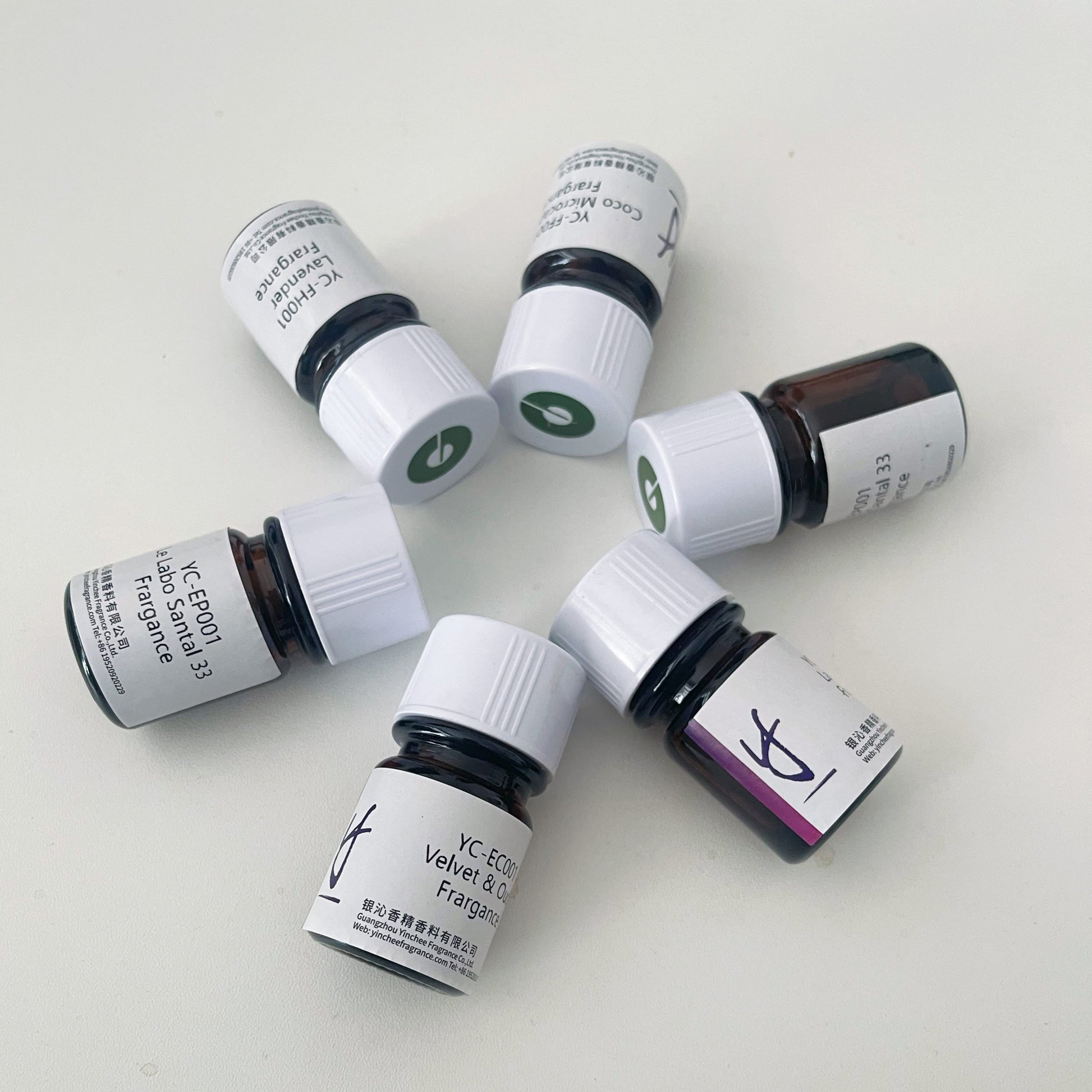 Circular arrangement of Yinchee Fabric Care Fragrance Oil sample vials showcasing Lavender, Citrus & Floral scent options
